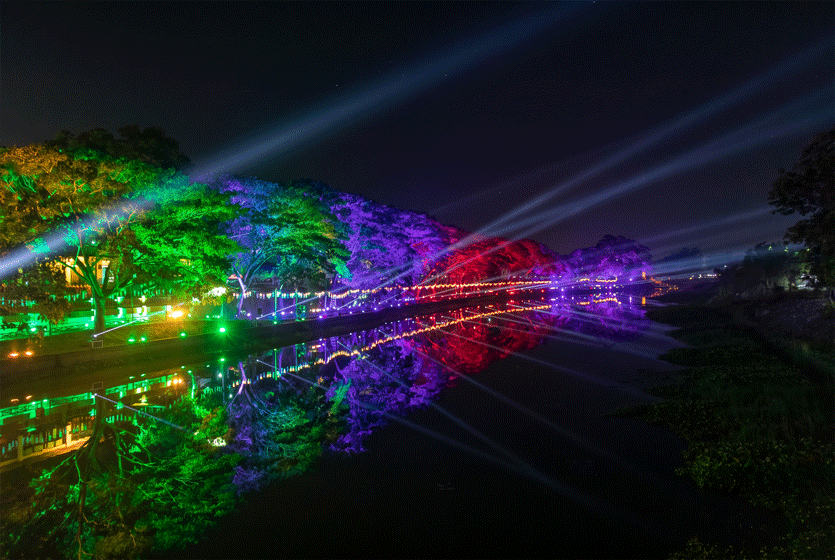 Night lights reflected across a lakeside scene